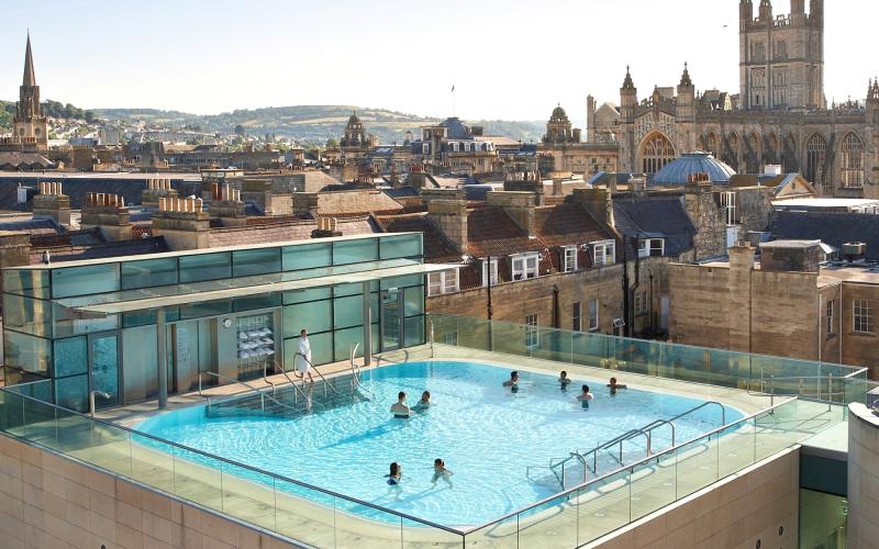 An aerial view of the rooftop pool at the Thermae Bath Spa in central Bath near Bristol, with Bath's skyline in the background