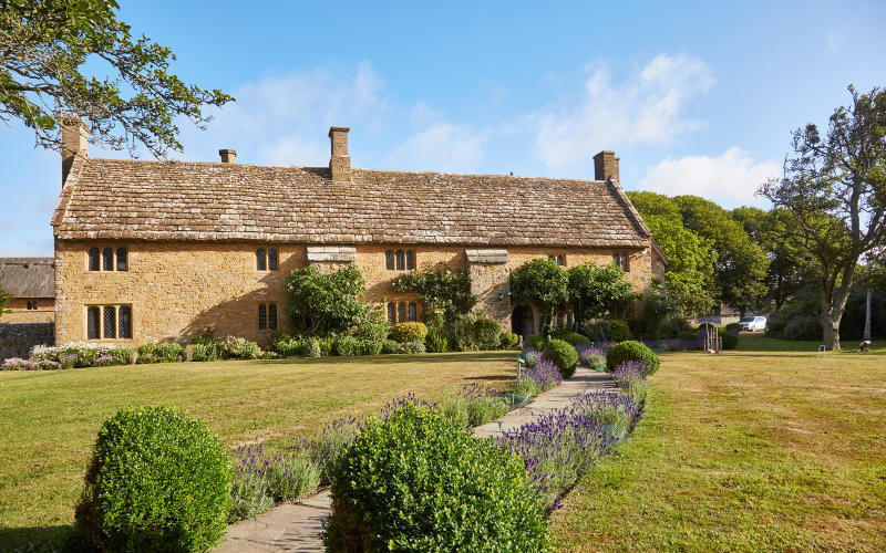 Bailiffscourt Hotel exterior of house with gardens and path in forefront