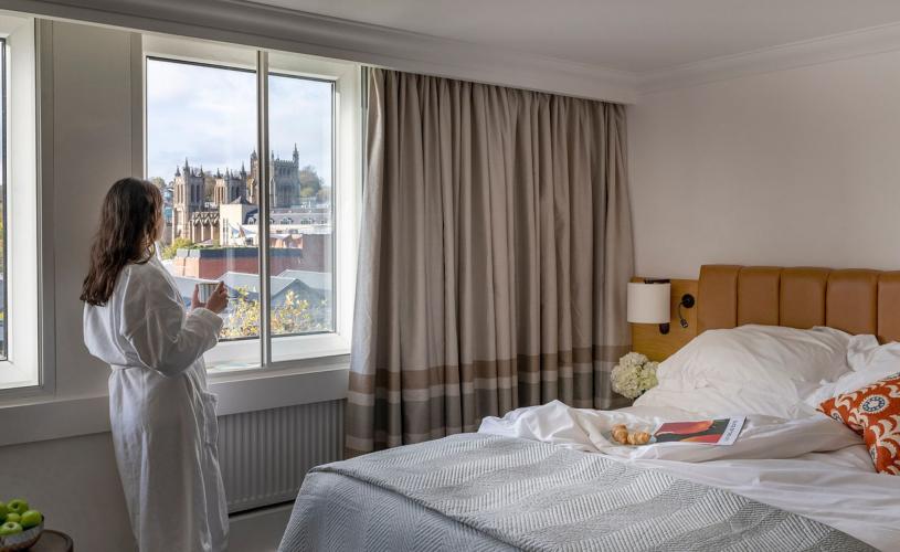a view of a woman looking out the window of Bristol Cathedral and The Harbourside at Leonardo Royal Hotel Bristol