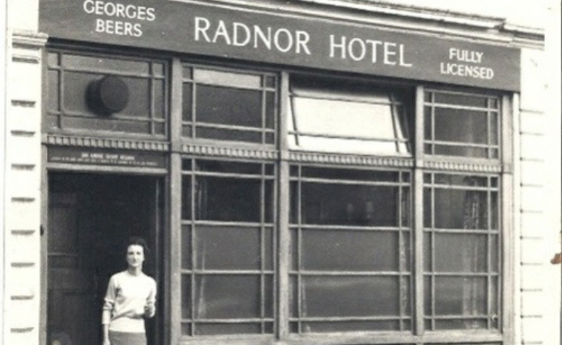A black and white photograph of a woman standing outside The Radnor Hotel in Bristol - credit University of Bristol