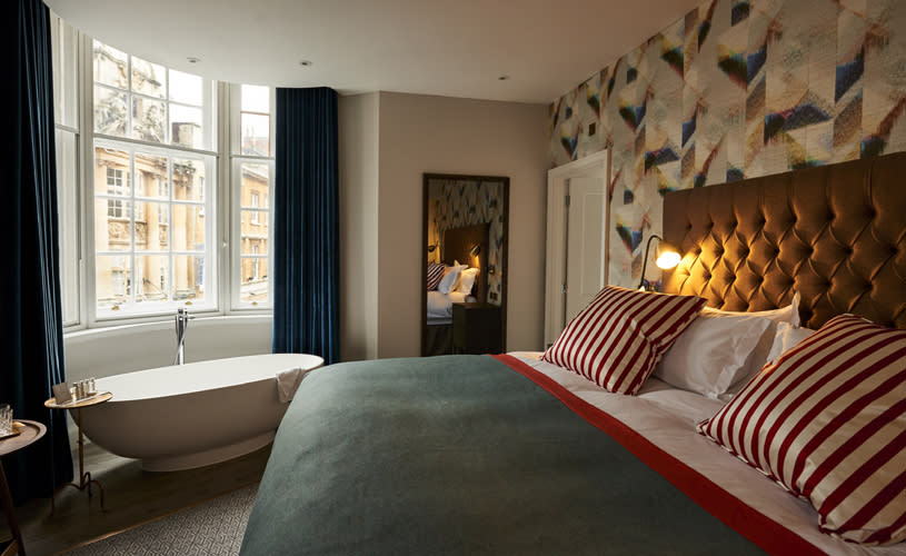 A large bedroom with a roll top bath tub in Harbour Hotel - Credit Harbour Hotel Bristol