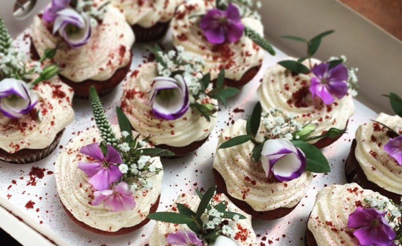 Cupcakes with purple flowers and green leaves - Credit Ahh Toots