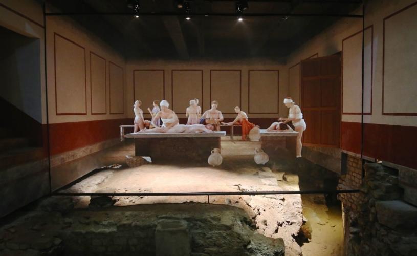 East Baths at The Roman Baths with projection of people