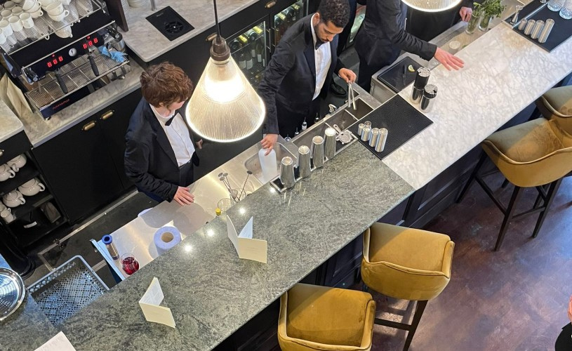 The bar area with waiters at the Aqua Grand Cafe in Redland, West Bristol