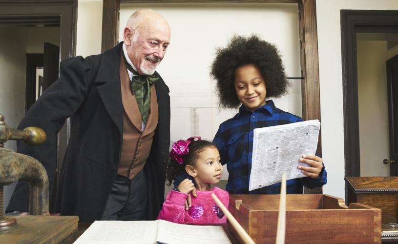 Man and children in Drawing Office at Being Brunel museum - credit Brunel's SS Great Britain
