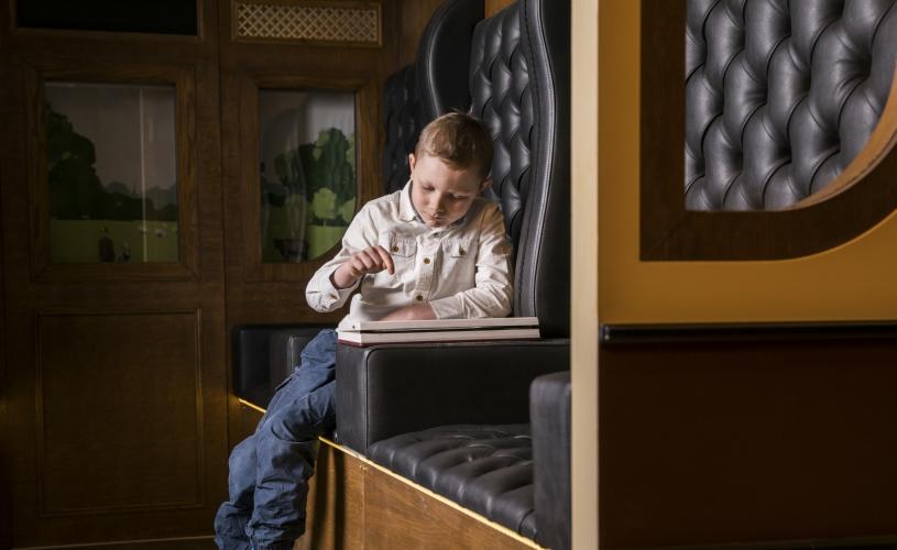 Child sat in replica train carriage at Being Brunel museum - credit Brunel's SS Great Britain