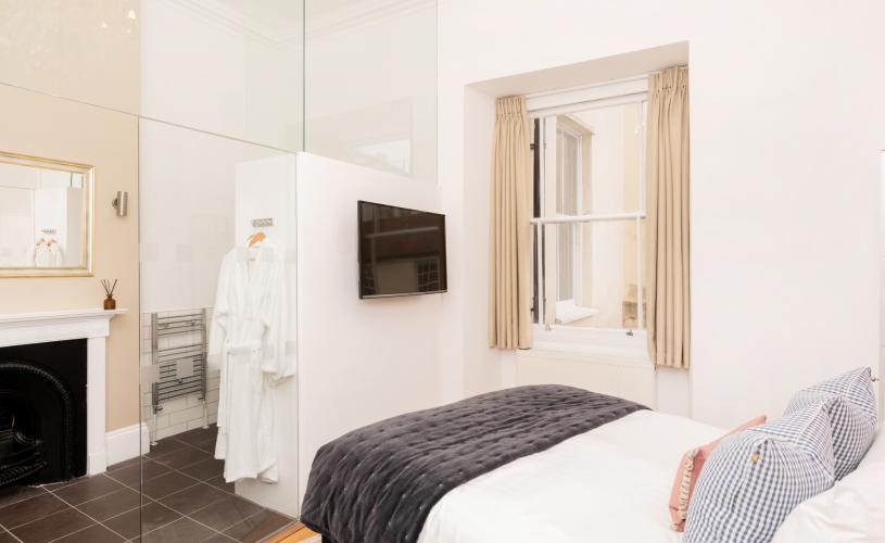 White bedroom with simple decor - Credit Berkeley Suites