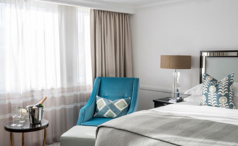 Doyle collection - The Bristol hotel Bedroom with a double bed and bottle of Champagne