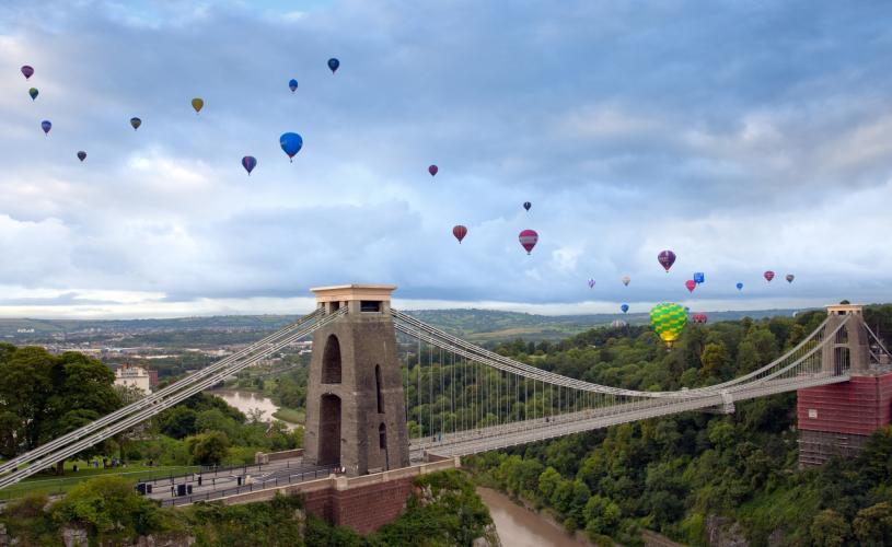 Balloons flying over the Clifton Suspension Bridge in West Bristol during one of the morning mass ascents from the Bristol Balloon Fiesta - credit Gary Newman