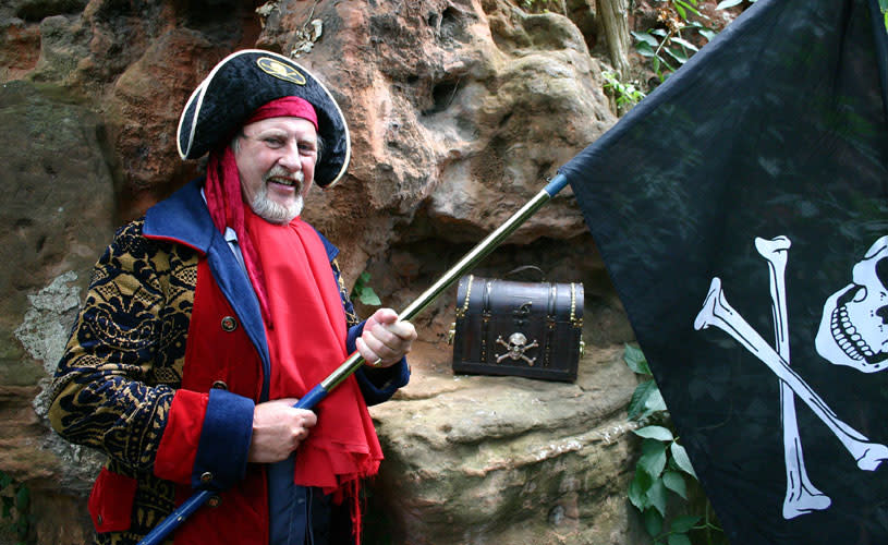 Man in pirate costume with flag - credit Bristol Pirate Walk