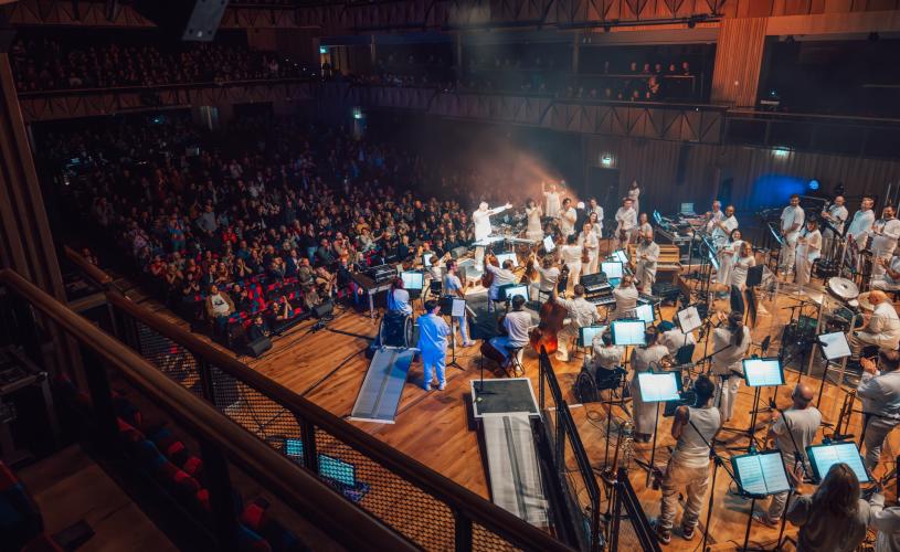 An orchestra performing on the stage inside the Beacon Hall at Bristol Beacon - credit Shotaway