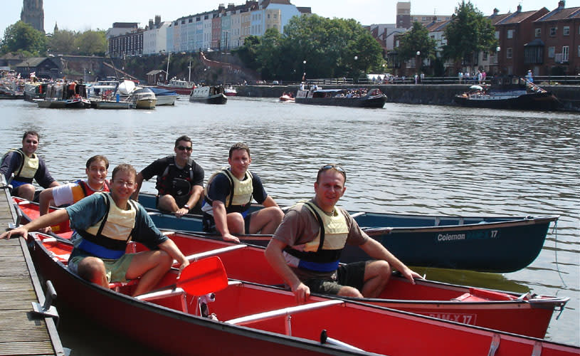 A group of men in a canoe on Bristol's Harbourside - credit Adventurous Activity Company