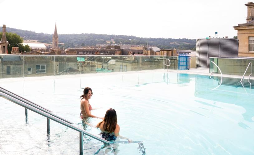 People in the rooftop pool at the Thermae Bath Spa at night - credit Ioan Said Photography