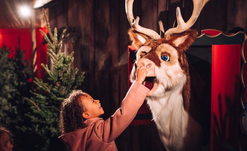 Child with toy reindeer at Avon Valley Adventure and Wildlife Park - Credit Avon Valley Adventure and Wildlife Park