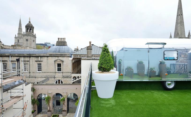 A silver airstream on a roof overlooking city - Credit Brooks Guesthouse