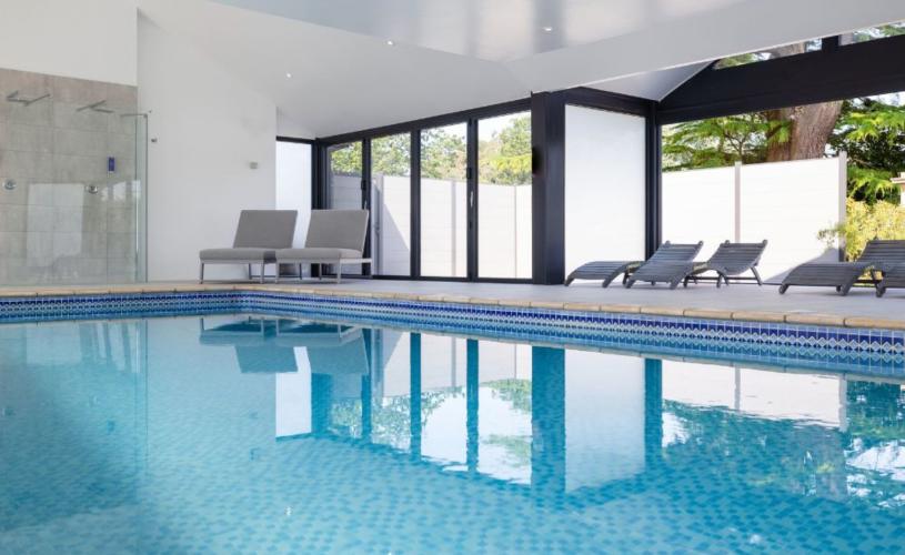 Indoor pool with loungers at Foxhills Spa - credit Old Down Estate