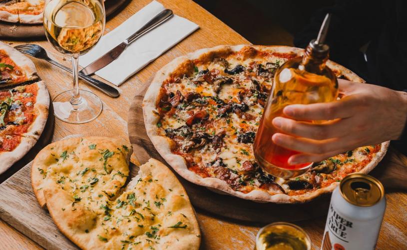 People holding pizzas - credit The Stable
