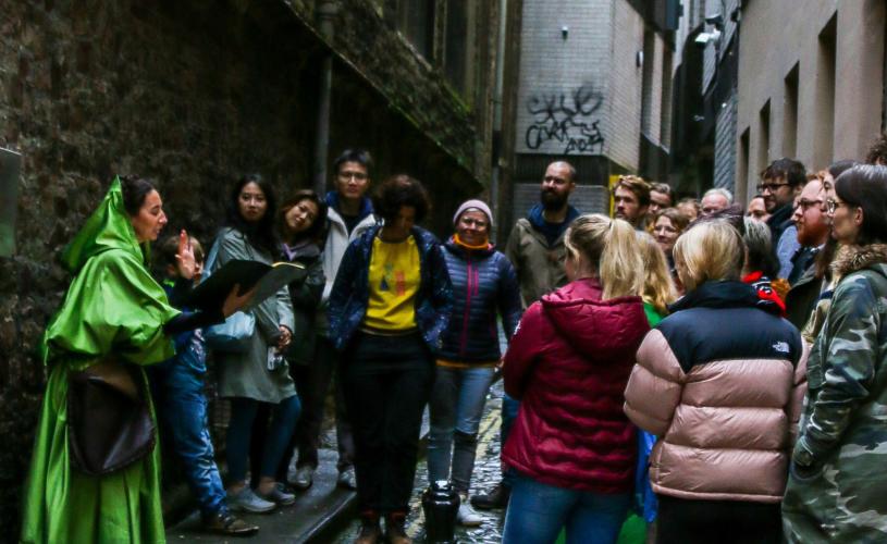People on a walking tour in central Bristol with costumed guide - credit Show Of Strength Theatre Company