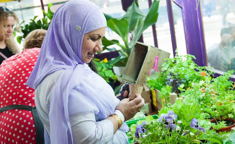 Woman looking at plants at the We The Curious in Bristol - credit Jon Craig