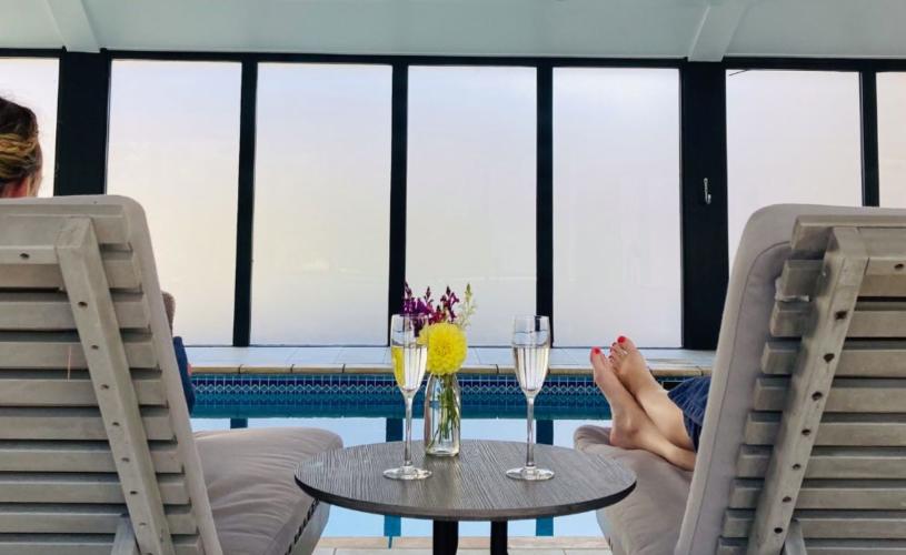 People relaxing in a spa with glasses of Champagne - credit  Foxhills Spa at Old Down Estate