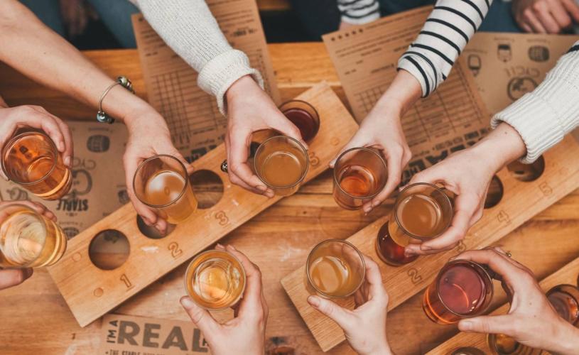 People holding glasses of cider - credit The Stable