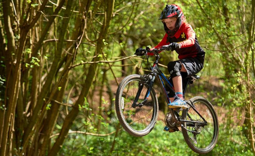 Teenager on mountain bike in forest - credit Pedal Progression