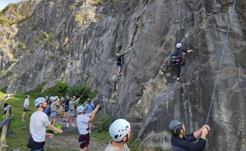 People climbing up cliff - credit Up & Under Adventures