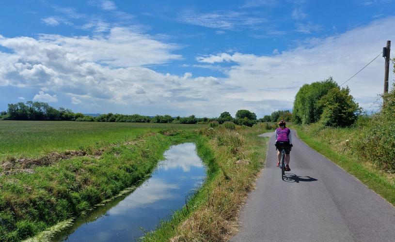 Cycling alongisde field on the Pier to Pier Cycle Route - credit Hallam Greene
