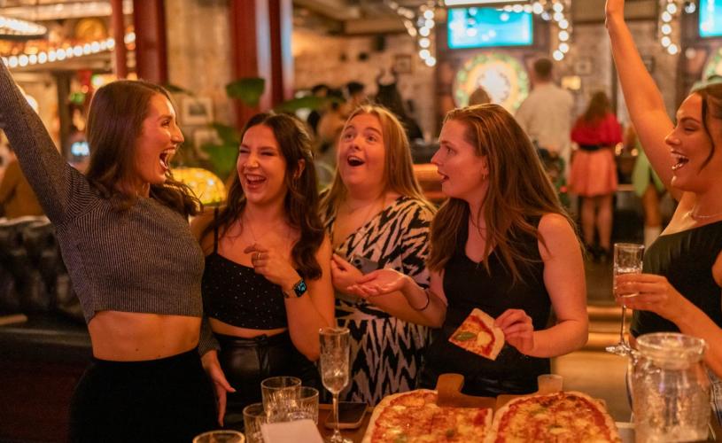 Group celebrating with pizza - credit Flight Club