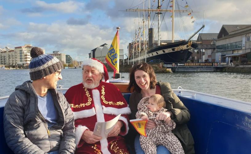 Santa sat on a boat with a mother and child - Credit Bristol Ferry