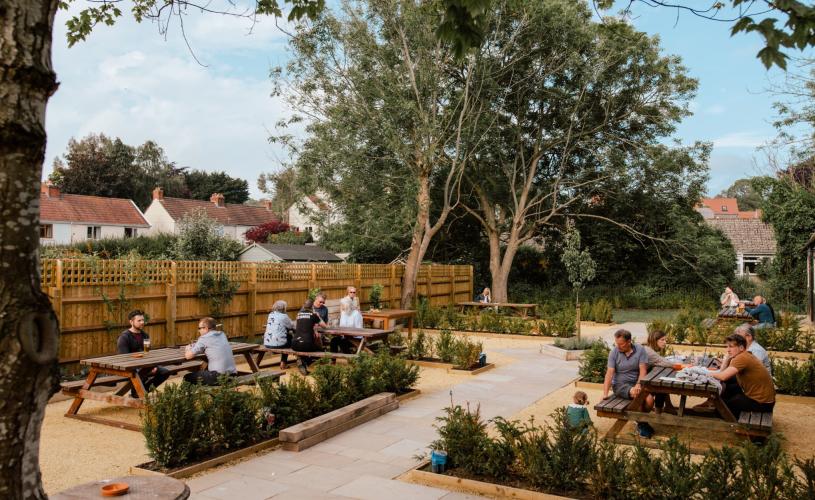 People sat in the beer garden at The Queens Chew Magna near Bristol - credit The Queens Chew Magna