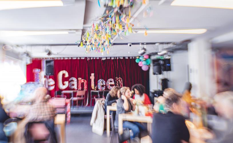 Tables and stage inside restaurant - credit Canteen