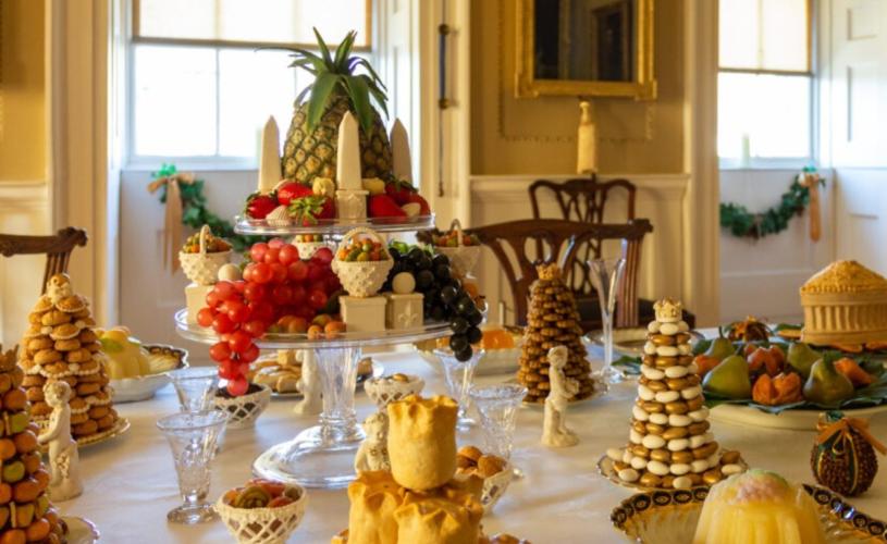 An image of several intricate Christmas foodstuffs arranged in an aesthetically pleasing manner on a table inside the No.1 Royal Crescent museum in Bath.