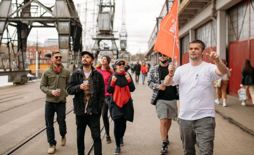 A group of people on the Cider Box walking tour of Bristol outside the M Shed local history museum on Bristol's Harbourside - credit Yuup