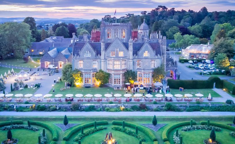 Grand mansion hotel surrounded by landscaped gardens