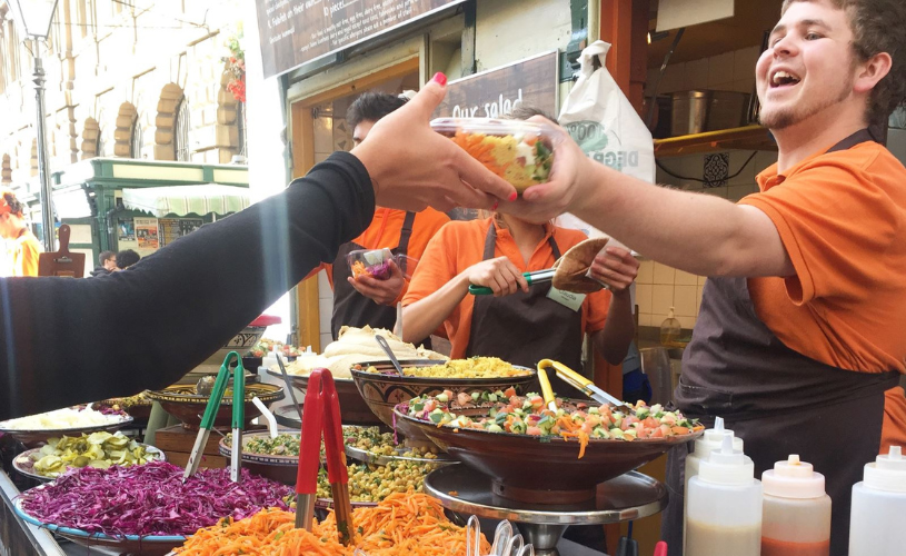 Staff members serving food at the Eat a Pitta stand in St Nicholas Market in Bristol's Old City - credit Eat a Pitta
