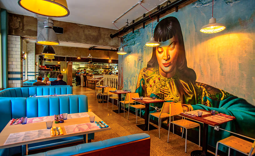 Blue booth tables and large mural at Bambalan, Bristol - credit Bambalan