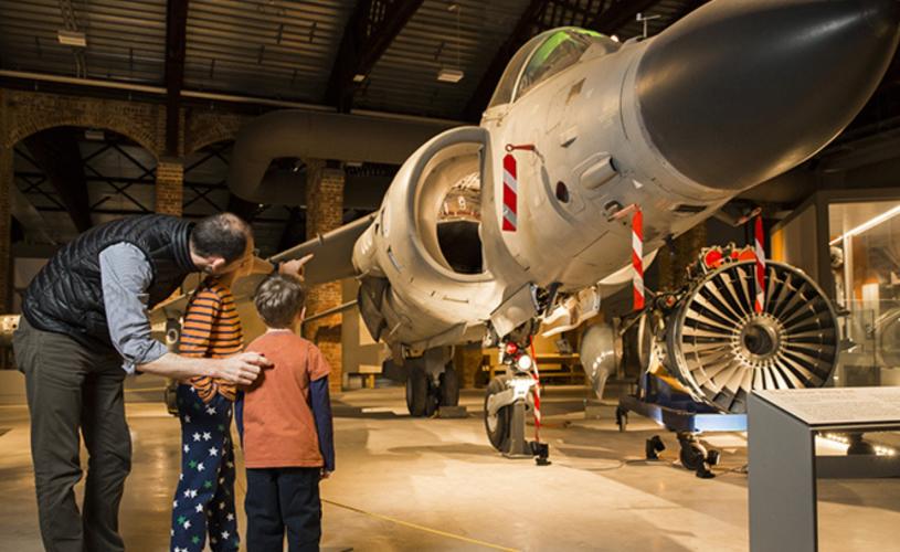 A father with his two children in the Aerospace Galleries at Aerospace Bristol