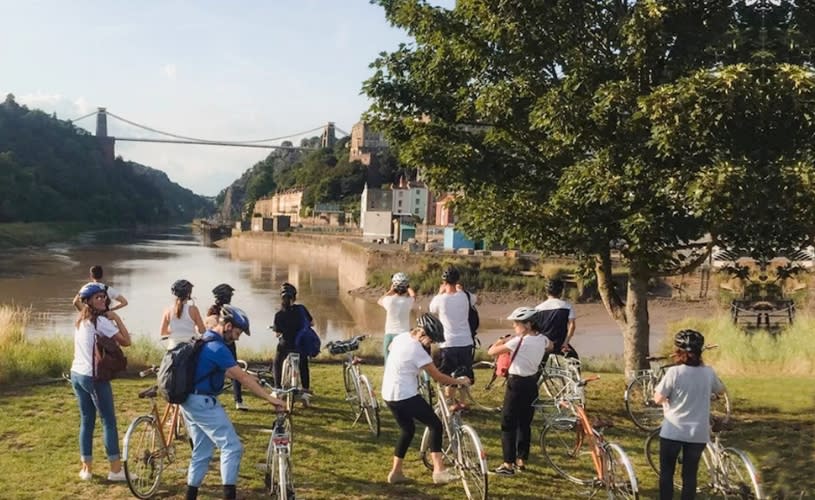 A group of cyclists looking out towards Clifton Suspension Bridge in central Bristol - credit Cycle the City