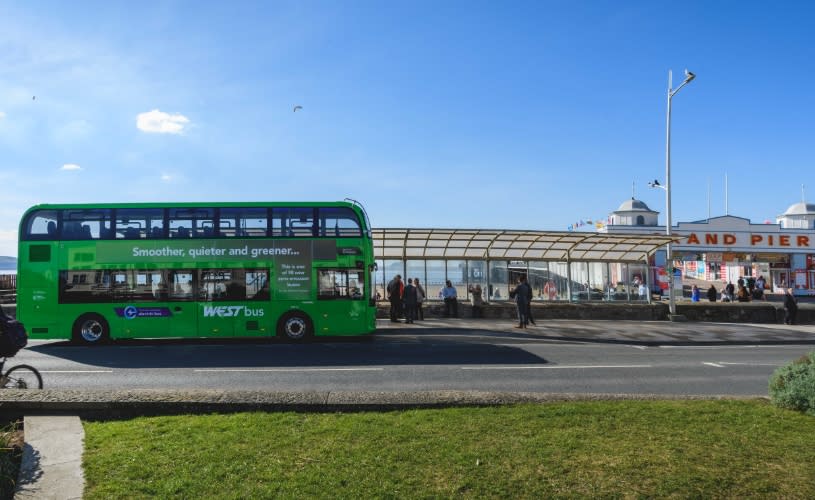 A green-coloured fully electric X1 bus parked on Marine Parade outside The Grand Pier in Weston-super-Mare, Nortrh Somerset - Jon Craig