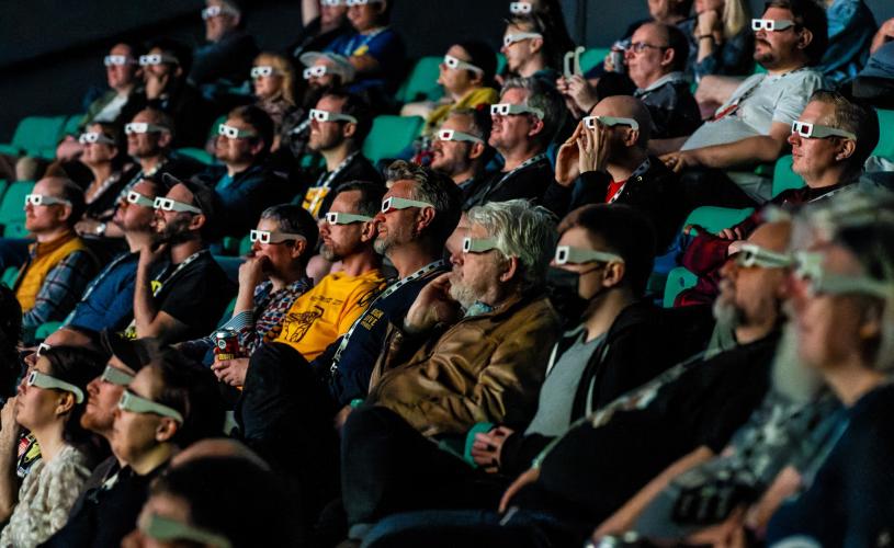 Audience watching film with 3D goggles