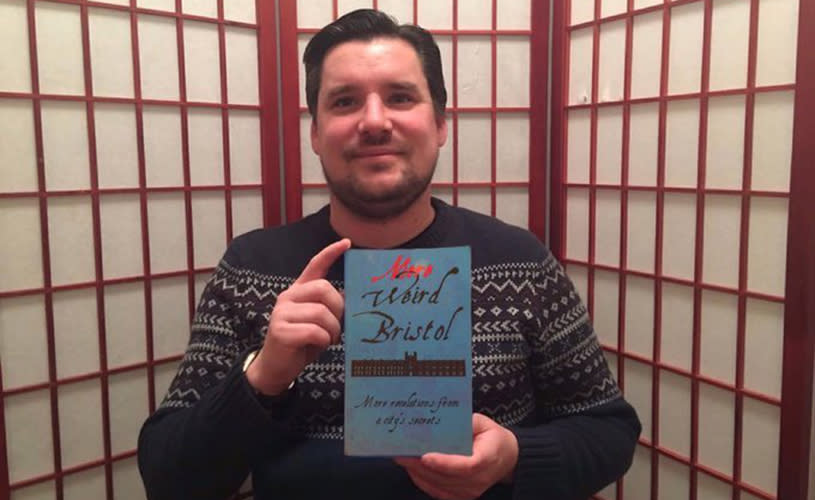 Author Charlie Revelle-Smith holding a copy of his book 'More Weird Bristol' - credit Charlie Revelle-Smith