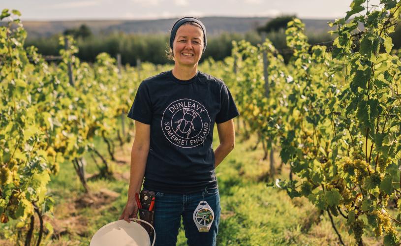 A woman standing in a vineyard in North Somerset near Bristol - credit GOOD Stories in Food