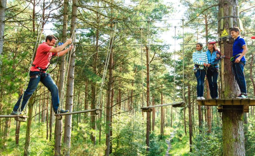 A family taking part in the Treetop Challenge at Go Ape Mallards Pike near Bristol - credit Go Ape