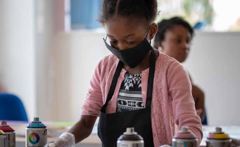 A young girl taking part in one of the street art workshops at Graft Bristol - credit Graft
