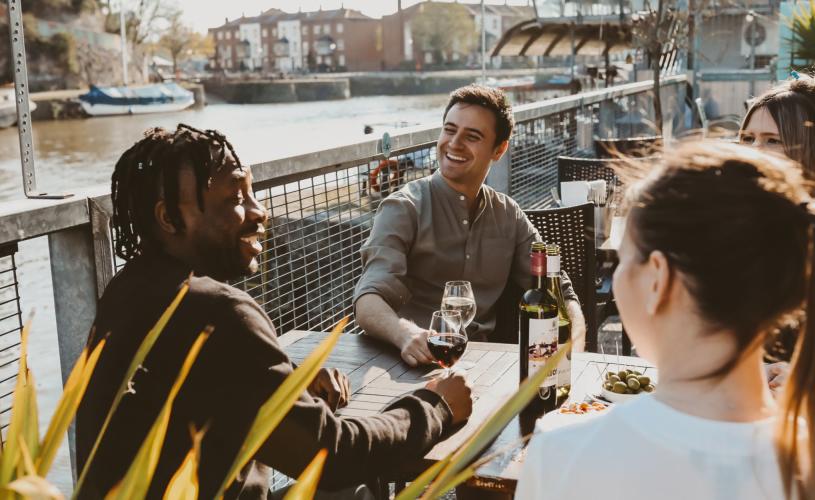Friends drinking wine on the terrace at Harbour House
