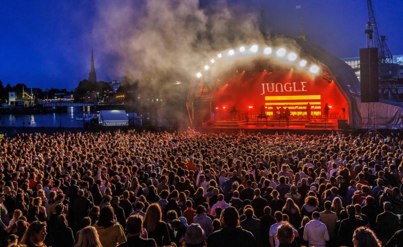 Jungle performing on the stage at Bristol Sounds with audience in foreground - credit Bristol Sounds