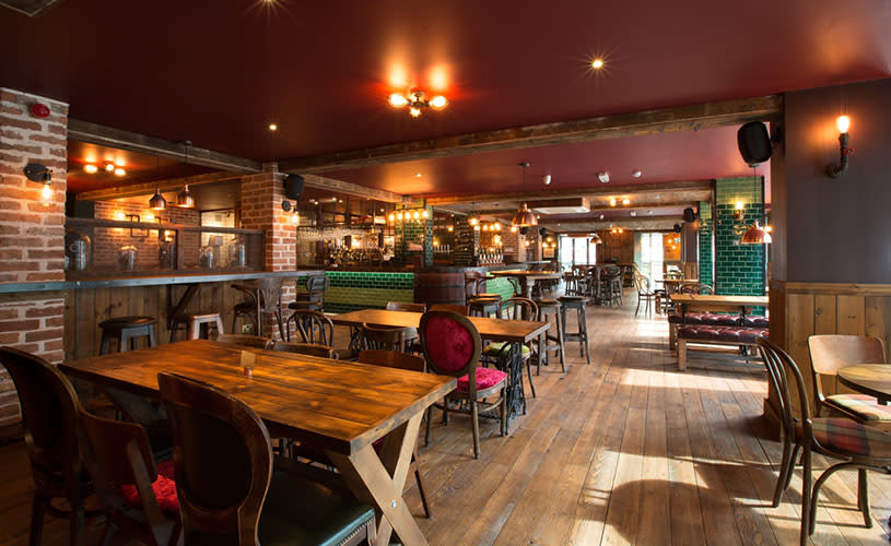 Interior of pub with wooden floors and tables - credit King Street Brew House