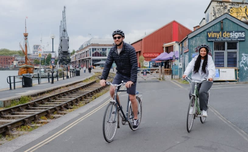 Two cyclists riding along the Harbourside Loop path in central Bristol near M Shed - credit Cycle the City