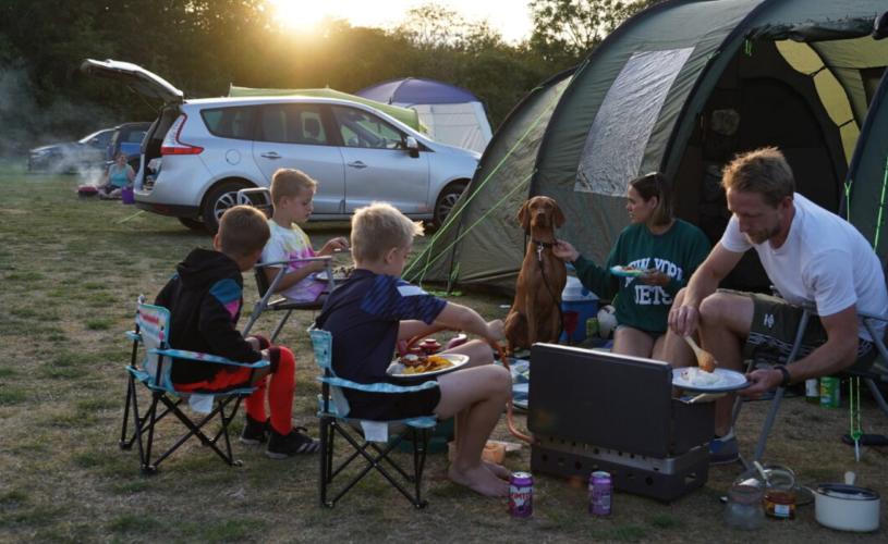 A family sat around a campfire - Credit Mendip Activity Centre